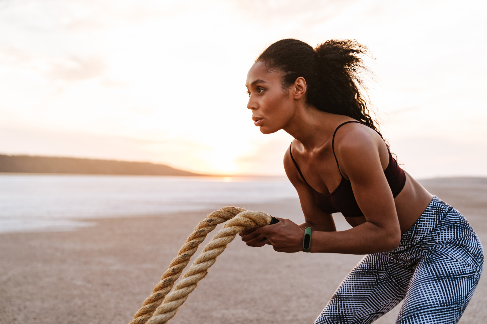 Image of African American Sportswoman Working Out with Battle Ropes